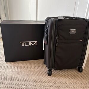 Brand New TUMI Black Rolling Suitcase with tags attached.
